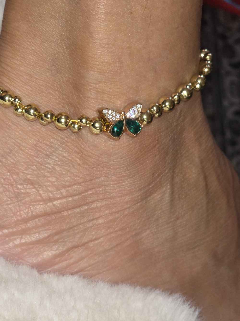 Gold Beaded Bracelet with Emerald Butterfly Charm